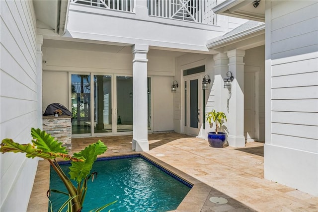 outdoor pool with a patio area