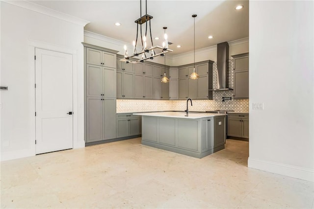 kitchen featuring ornamental molding, gray cabinets, wall chimney range hood, decorative backsplash, and baseboards