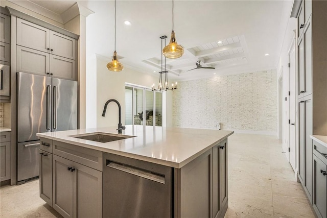 kitchen with a sink, beamed ceiling, appliances with stainless steel finishes, and gray cabinetry