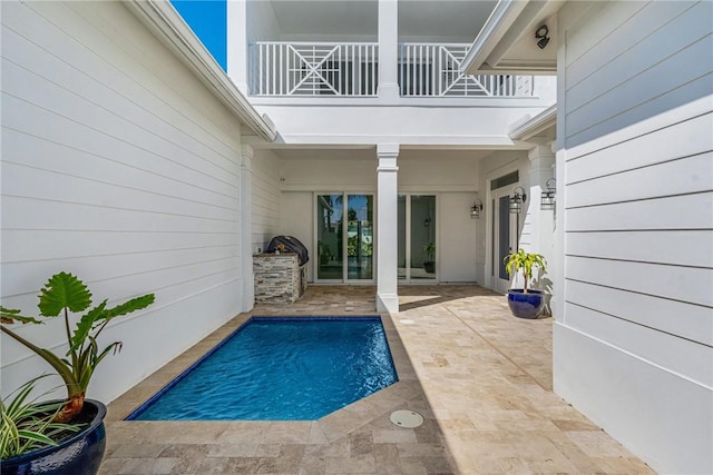 outdoor pool with a patio area