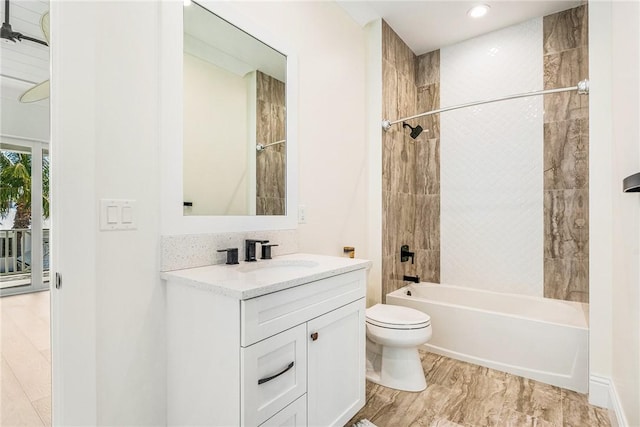 bathroom featuring tub / shower combination, toilet, and vanity