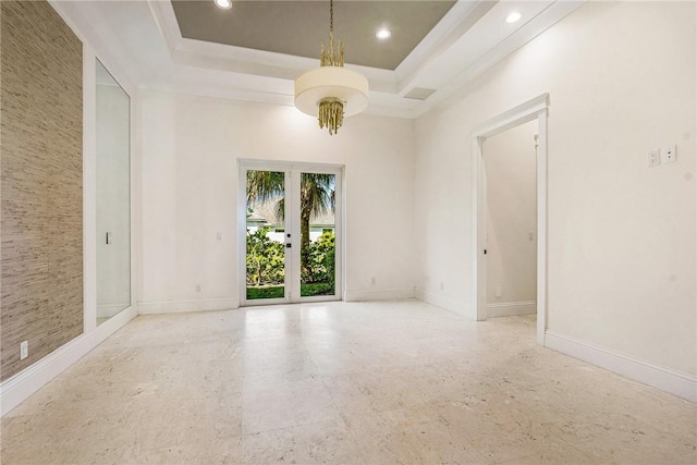 empty room featuring recessed lighting, french doors, a raised ceiling, and baseboards