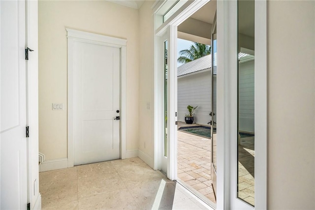 doorway to outside featuring baseboards