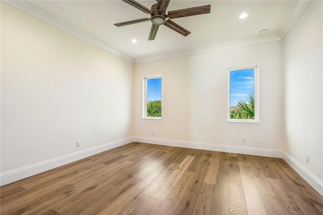 spare room featuring light wood-style flooring, ornamental molding, recessed lighting, baseboards, and ceiling fan