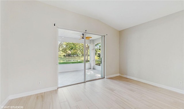 652 Hatteras Ct SW, Vero Beach, FL 32968 - empty room featuring wood finished floors, a ceiling fan, baseboards, and vaulted ceiling
