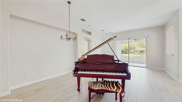 652 Hatteras Ct SW, Vero Beach, FL 32968 - living area featuring visible vents, baseboards, a notable chandelier, and light wood finished floors