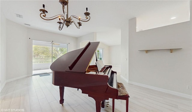 652 Hatteras Ct SW, Vero Beach, FL 32968 - sitting room featuring a notable chandelier, visible vents, light wood-type flooring, and baseboards