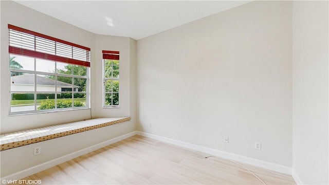 652 Hatteras Ct SW, Vero Beach, FL 32968 - empty room with plenty of natural light, light wood-style flooring, and baseboards
