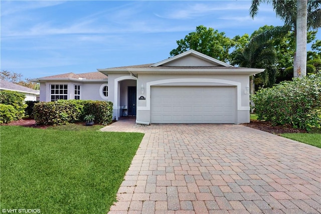 ranch-style house featuring a garage, decorative driveway, a front lawn, and stucco siding