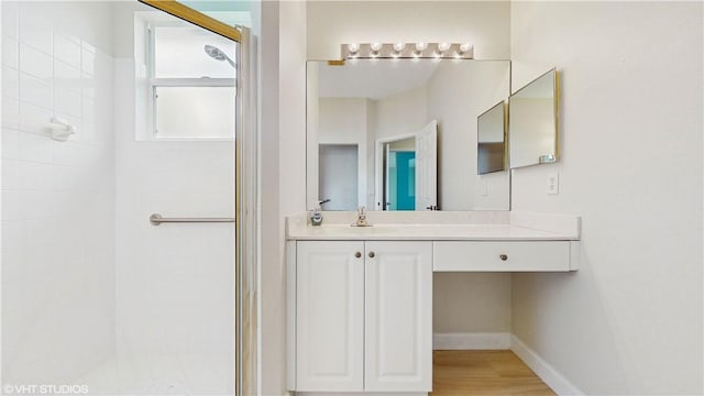 652 Hatteras Ct SW, Vero Beach, FL 32968 - full bath with tiled shower, vanity, baseboards, and wood finished floors