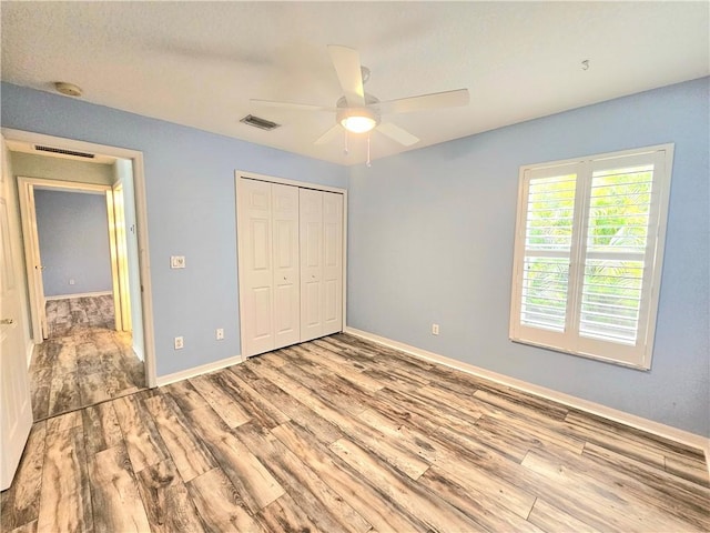 5057 5th Mnr, Vero Beach, FL 32968 - unfurnished bedroom featuring wood finished floors, baseboards, and a closet