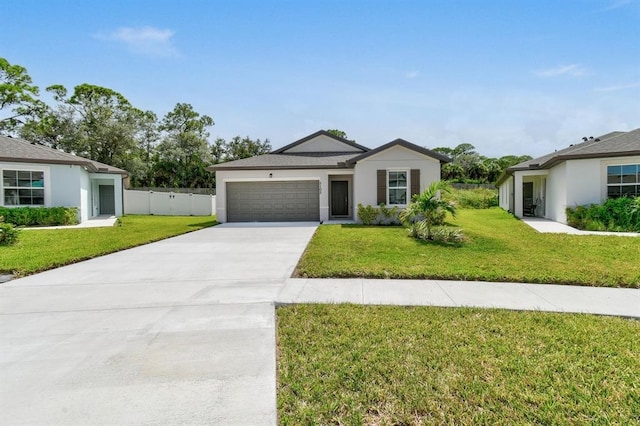 ranch-style house with a garage and a front lawn