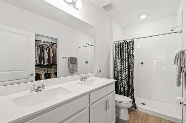 bathroom featuring toilet, hardwood / wood-style floors, vanity, and a shower with shower curtain