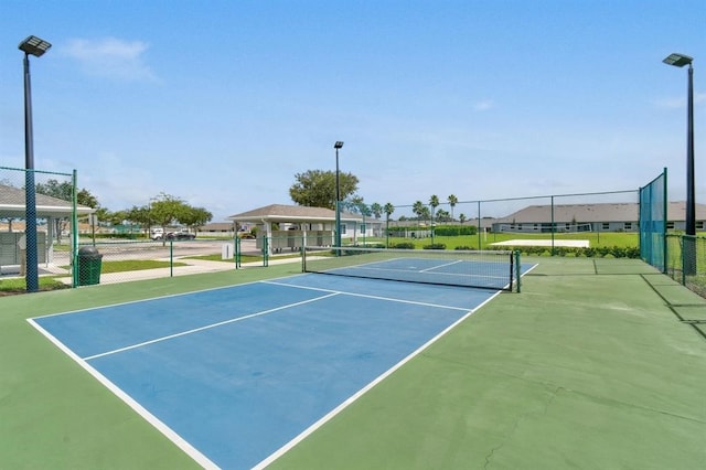 view of tennis court featuring basketball hoop