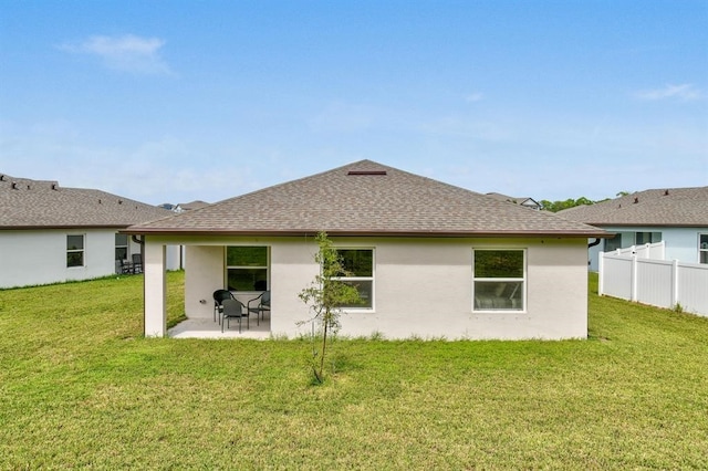 back of house with a yard and a patio area