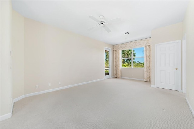 carpeted spare room with ceiling fan