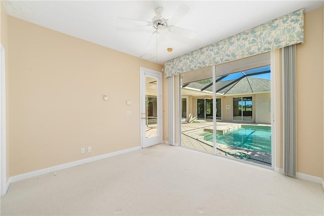 interior space with carpet floors and ceiling fan