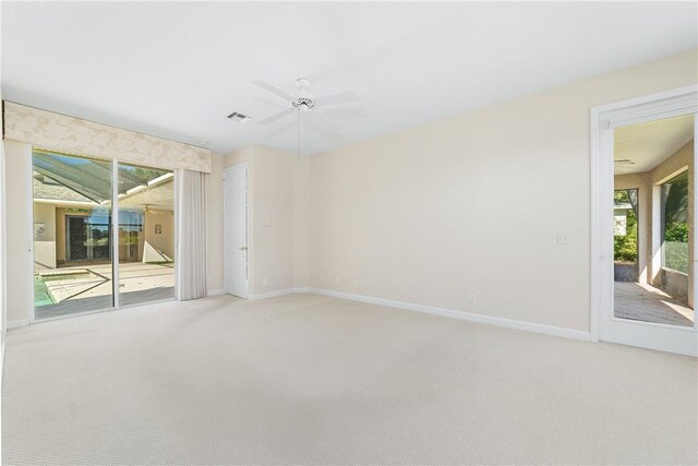 spare room with carpet floors and ceiling fan