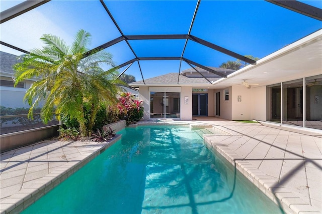 view of swimming pool featuring a lanai and a patio