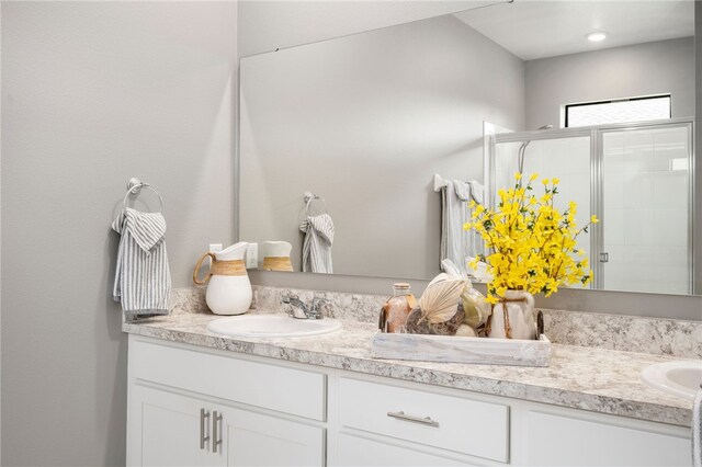 bathroom featuring vanity and an enclosed shower