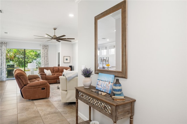 living room with ceiling fan and ornamental molding