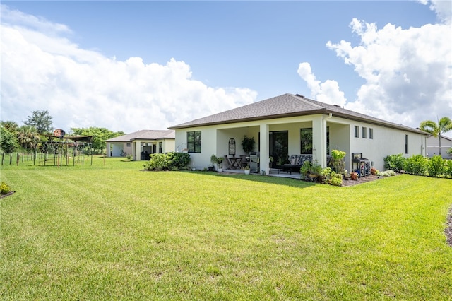 back of house with a lawn