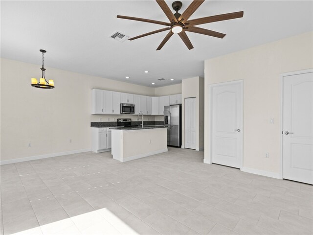 kitchen with white cabinetry, hanging light fixtures, a center island with sink, light tile patterned flooring, and appliances with stainless steel finishes