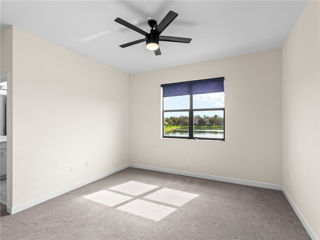 spare room with light carpet and ceiling fan