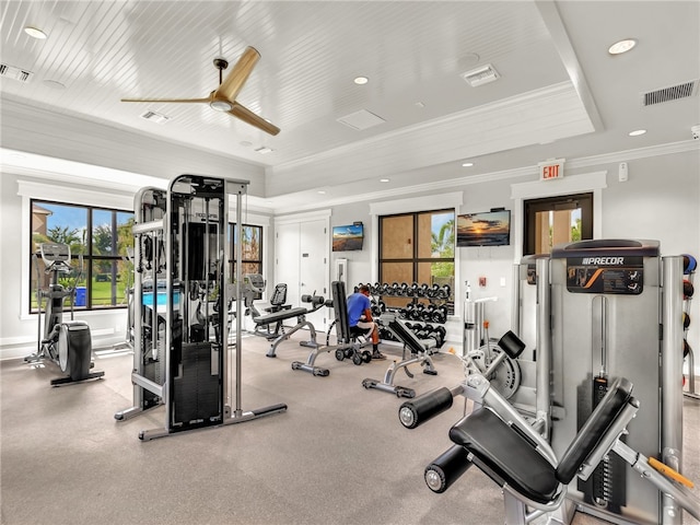 gym featuring ceiling fan and ornamental molding