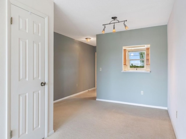 empty room featuring light carpet