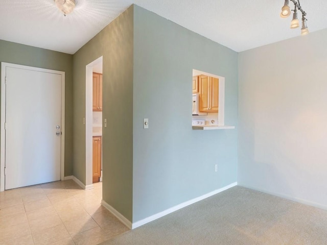 unfurnished room with light colored carpet