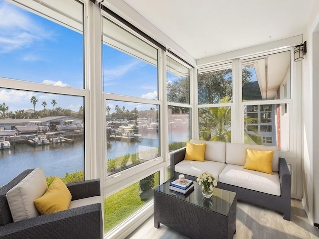 sunroom / solarium featuring a water view