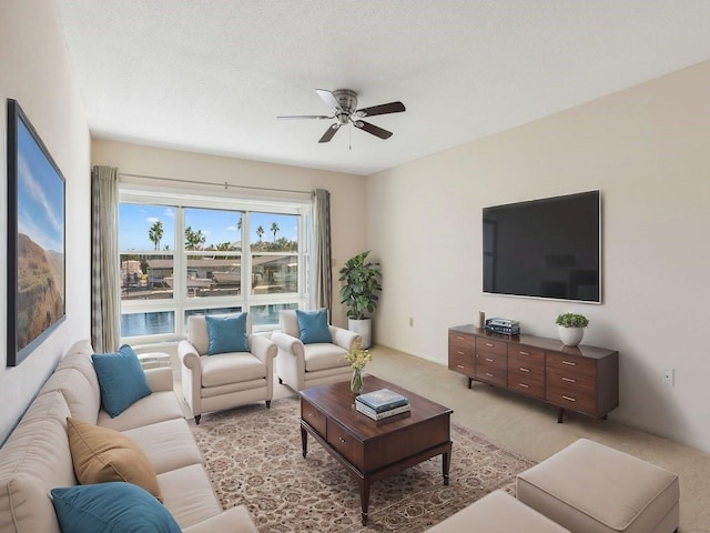 living room featuring light colored carpet and ceiling fan