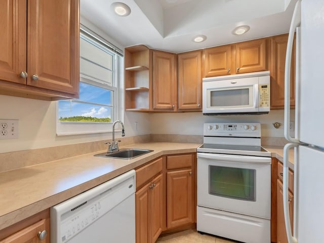 kitchen featuring white appliances and sink