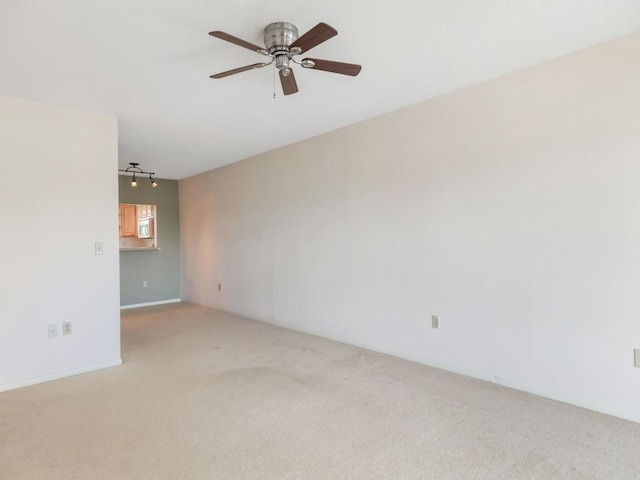 spare room featuring carpet flooring and ceiling fan