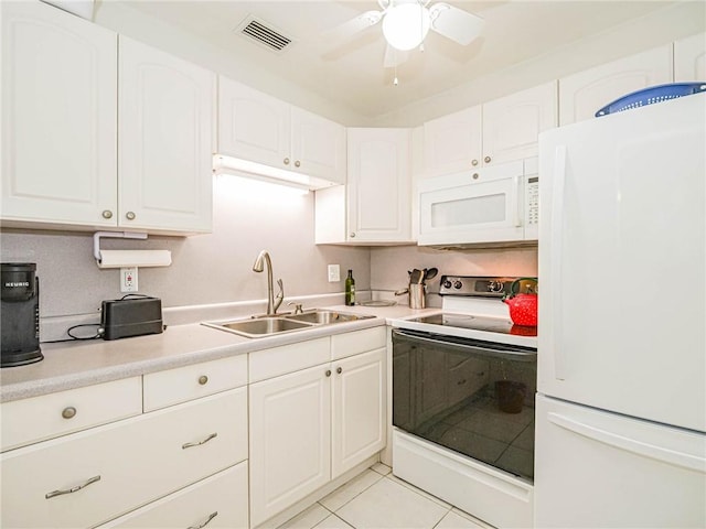 2800 Indian River Blvd Unit L8, Vero Beach, FL 32960 - kitchen with light tile patterned floors, sink, white cabinetry, and white appliances