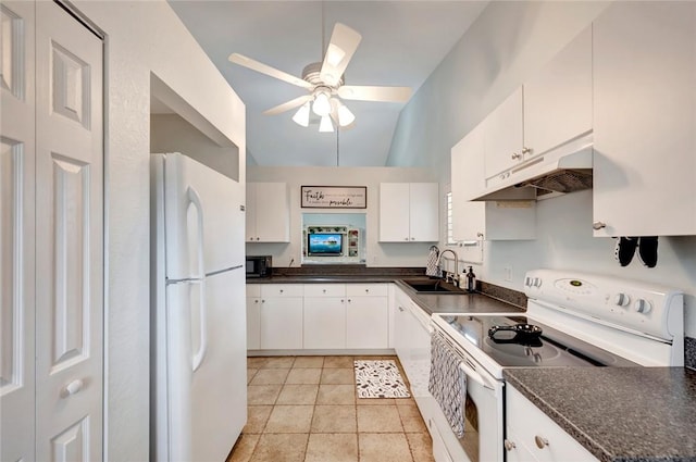 kitchen with dark countertops, white appliances, under cabinet range hood, and white cabinetry