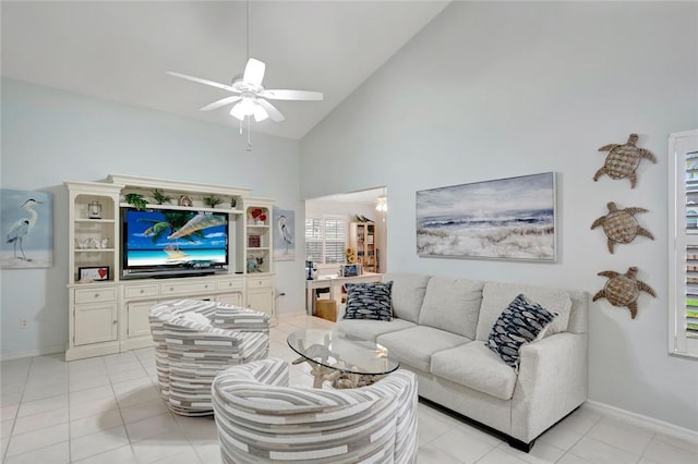 living room with high vaulted ceiling, light tile patterned flooring, a ceiling fan, and baseboards