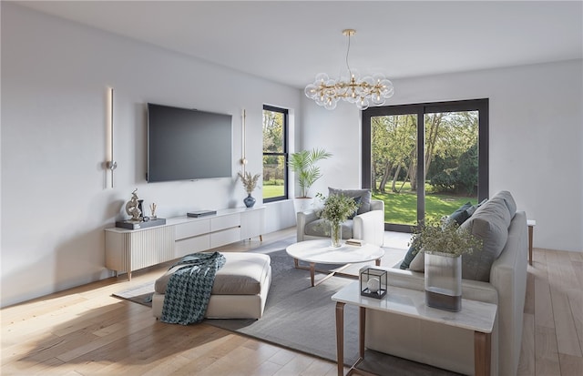 living room featuring an inviting chandelier, light hardwood / wood-style floors, and plenty of natural light