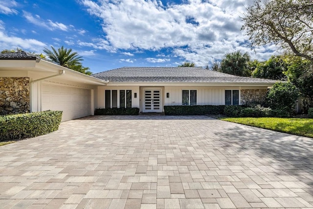 view of front of property featuring a garage and french doors