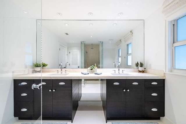 bathroom with vanity and a shower with door