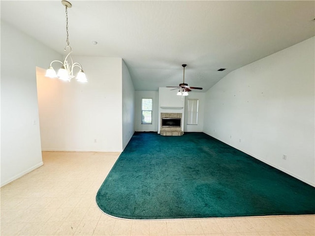 2054 14th Ave SW, Vero Beach, FL 32962 - unfurnished living room with a tile fireplace, a chandelier, ceiling fan, vaulted ceiling, and baseboards