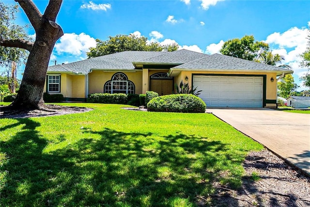 2054 14th Ave SW, Vero Beach, FL 32962 - single story home with an attached garage, stucco siding, driveway, and a front lawn