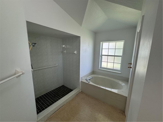 2054 14th Ave SW, Vero Beach, FL 32962 - full bath featuring a tile shower, a garden tub, lofted ceiling, and a textured ceiling