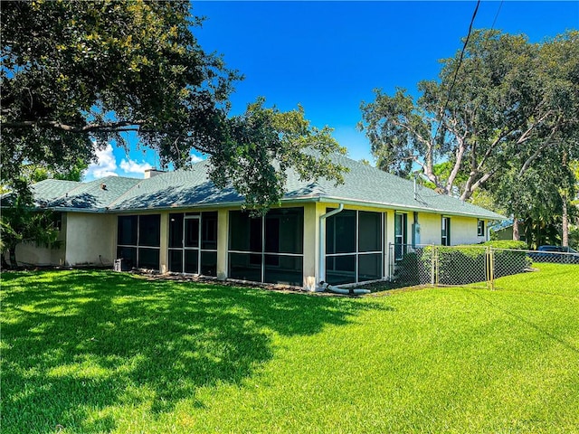2054 14th Ave SW, Vero Beach, FL 32962 - rear view of house featuring a sunroom and a shingled roof