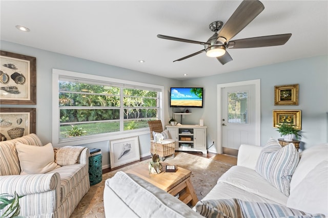 living room featuring plenty of natural light and ceiling fan