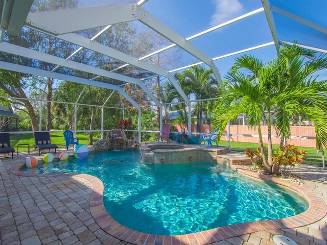 view of swimming pool featuring a lanai, a patio, pool water feature, and an in ground hot tub