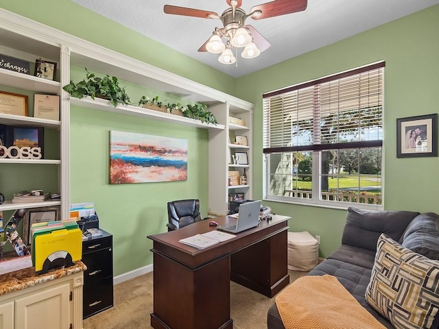 home office featuring ceiling fan and light carpet