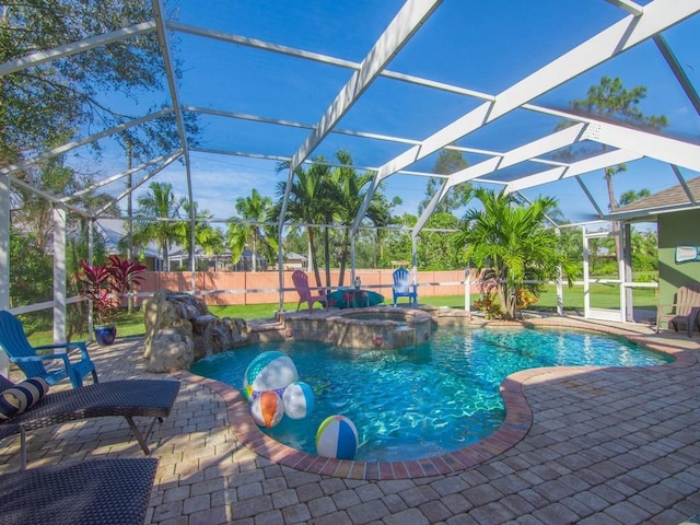 view of swimming pool featuring a lanai, a patio area, and an in ground hot tub