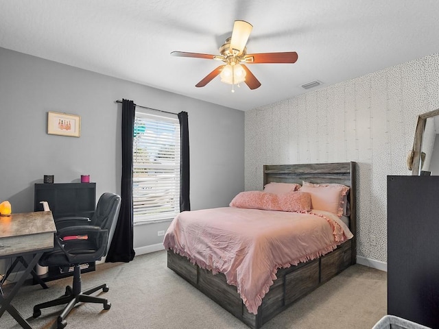 bedroom with ceiling fan and light colored carpet